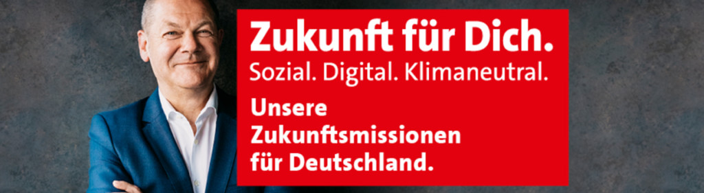 Porträt mit Olaf Scholz und einem roten Banner, auf dem folgender Text steht: Zukunft für Dich. Sozial. Digital. Klimaneutral. Unsere Zukunftsmission für Deutschland